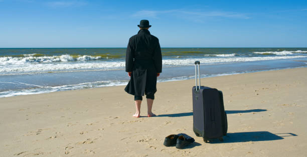 istock Arrival of black dressed tourist at the beach 682183318