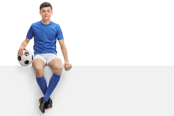 istock Teen football player sitting on a panel 682197194