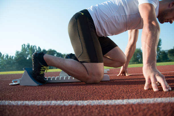 istock Runners preparing for race at starting blocks 682205120