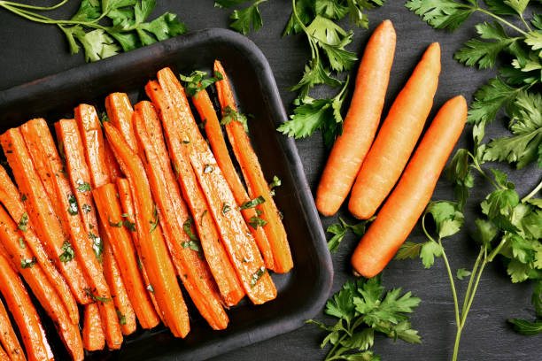 istock Roasted carrots with green herbs 682208262