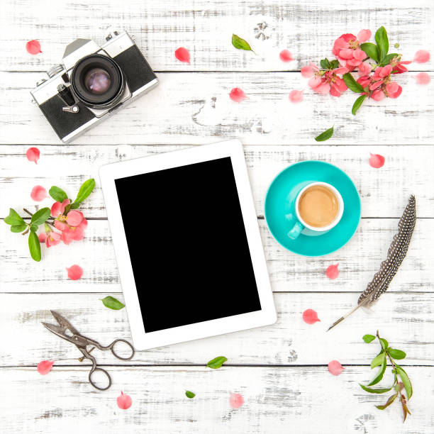 istock Tablet PC photo camera coffee pink flowers Spring flat lay 682212998