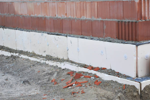 istock House foundation Insulation.  Insulating home  foundation walls with insulation styrofoam sheets for House Energy Saving. 682216032