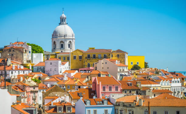 Lisbon terracotta rooftops of Alfama overlooked by Panteao Nacional Portugal The terracotta rooftops of the iconic Alfama district overlooked by the dome of the Panteao Nacional in the heart of Lisbon, Portugal’s vibrant capital city. estuary photos stock pictures, royalty-free photos & images