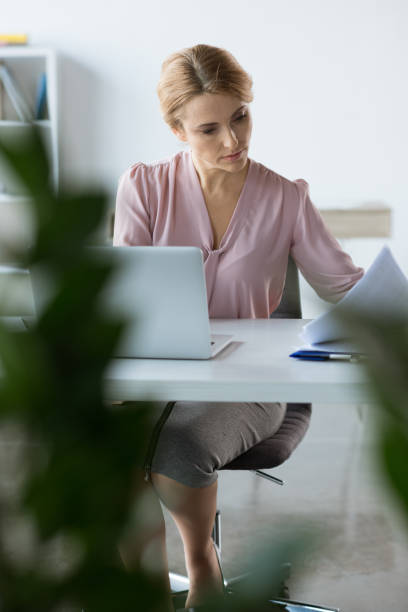 istock serious businesswoman working with documents 682222186