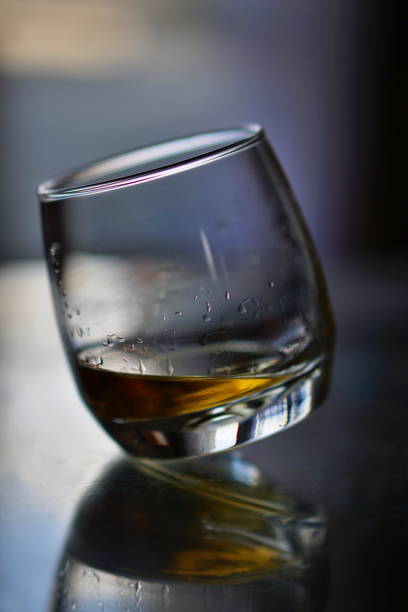 istock Off-balanced whiskey glass with golden liquor 682222836