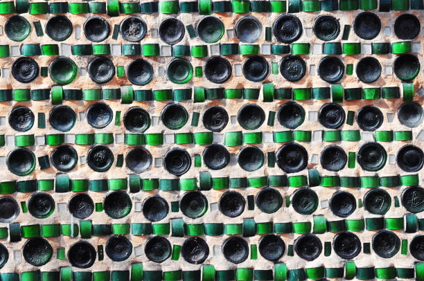 istock Colorful recycling background texture of empty wine bottles in the wall construction. 682229822