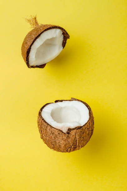 istock Coconut on yellow colored background, minimal flat lay style 682231622