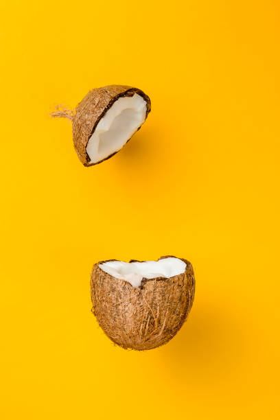 istock Coconut on yellow colored background, minimal flat lay style 682231626