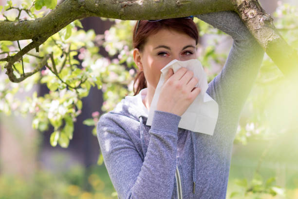 Suffering from pollen allergy Young woman suffering from Pollen allergy, alergy season, Girl blowing her nose hayfever stock pictures, royalty-free photos & images