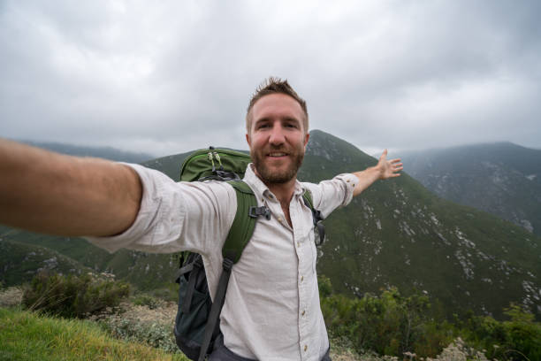 istock Young man taking selfie with mountain view 682236920