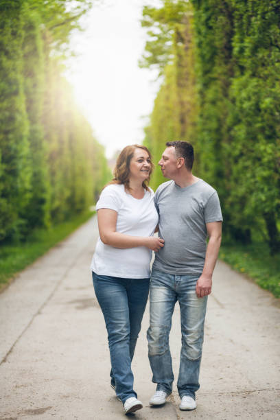 istock Happy loving couple on a romantic walk outdoors in park 682243586