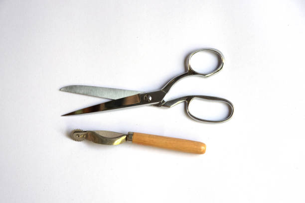 istock metal scissors and roller for sewing isolated on white background 682247526