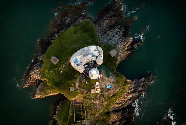 Bird's eye view of the iconic the Mumbles lighthouse structure in Swansea Bay, Gower, South Wales, UK