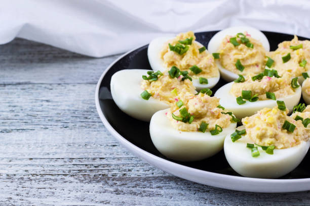 istock Home eggs stuffed with cheese and crab topped with green onions 682255260