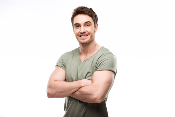istock handsome man standing with crossed arms and looking at camera isolated on white 682257744