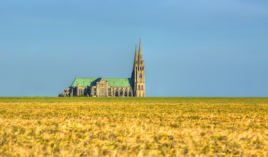 Image of the Cathedral of Our Lady of Chartres seen from outside of the city above the fields of cereals which surround the locality.This is a very famous Gothic cathedral which contains original stained glass from the 13th century.