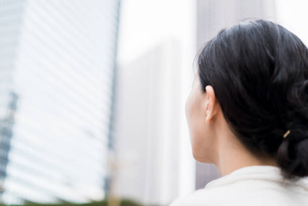 istock Woman looking at office buildings 682260900