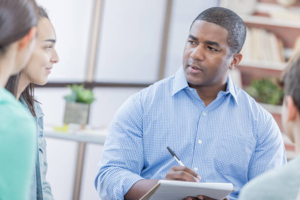 istock African American counselor talks with young people 682261818
