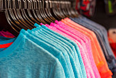Row of colored t-shirts in a store