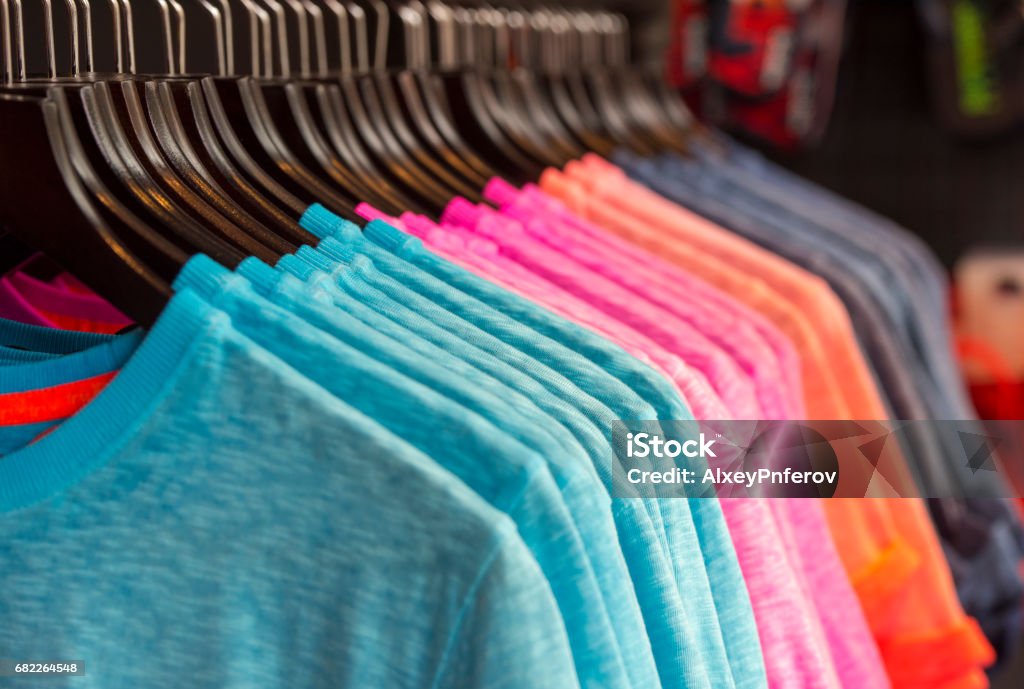 Row of colored t-shirts in a store T-Shirt Stock Photo