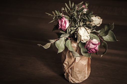 Bouquet of dried red and white roses, low key
