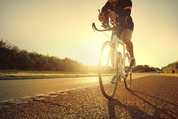 istock Athlete on bike riding on empty road 682268436