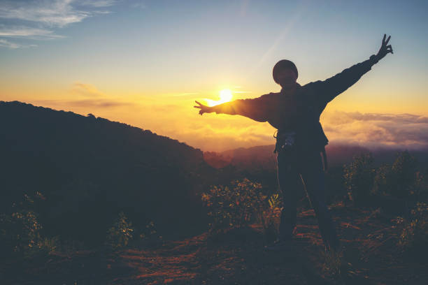 istock Silhouette Freedom man standing with raised arms and enjoying on time 682268590