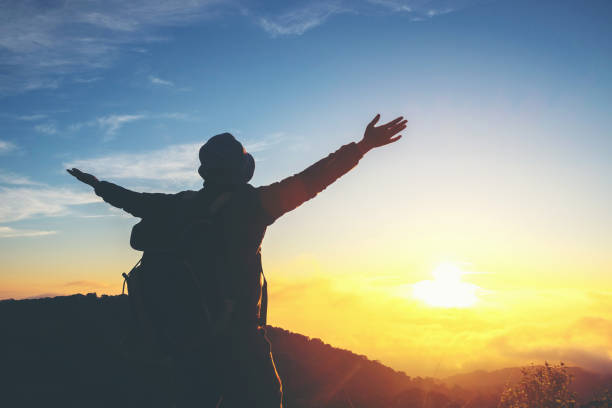 istock Silhouette Freedom man standing with raised arms and enjoying on time 682268698