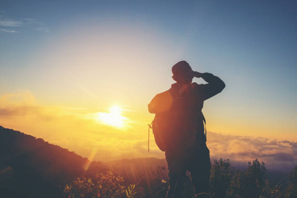 istock Silhouette Freedom man standing with raised arms and enjoying on time 682268754