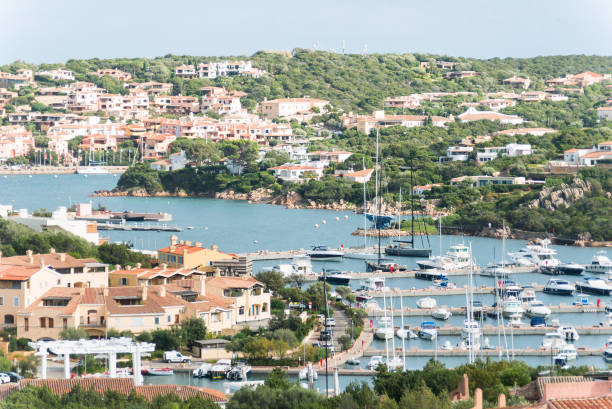 Scenery with Marina and luxury yachts at Mediterranean Sea of Porto Cervo in Sardinia Island of Italy in summer. Landscape View on Sardinian town port with ships and boats in Sardegna. Mixed media.