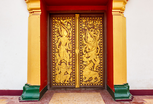 Ancient Golden carving wooden window of Thai temple in Thailand.