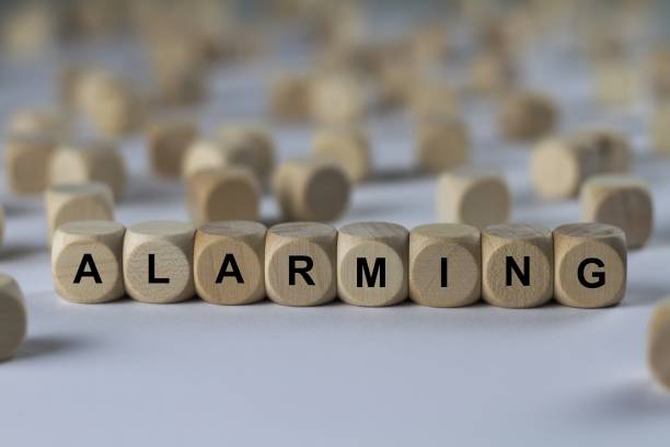 istock alarming - cube with letters, sign with wooden cubes 682279382