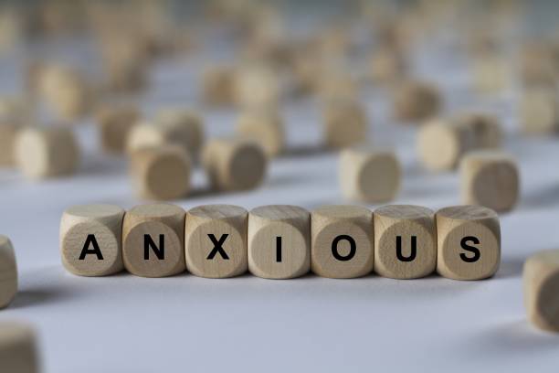anxious - cube with letters, sign with wooden cubes - solicitous imagens e fotografias de stock