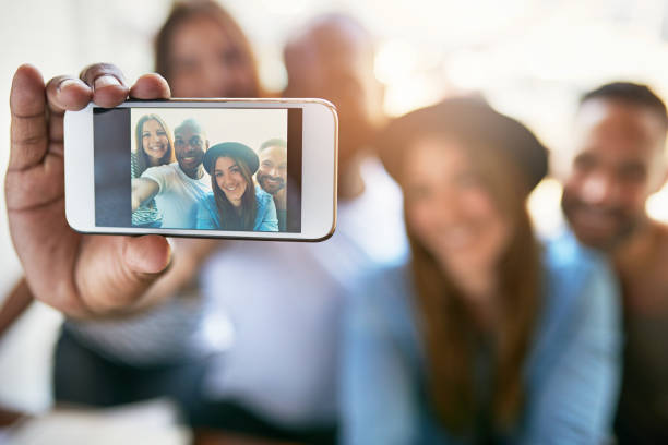 istock Male hand holding phone and taking selfie 682282586