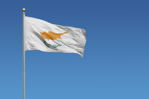 Flag of Cyprus in front of a clear blue sky
