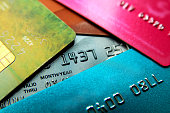 Stack of multicolored credit cards close-up view with selective focus.