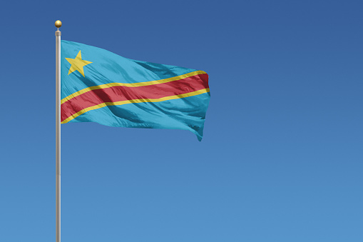 Flag of Democratic Republic of the Congo in front of a clear blue sky