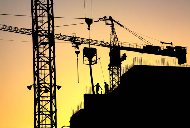 istock Orange glow Sunset over an Apartment Construction Site 682288964