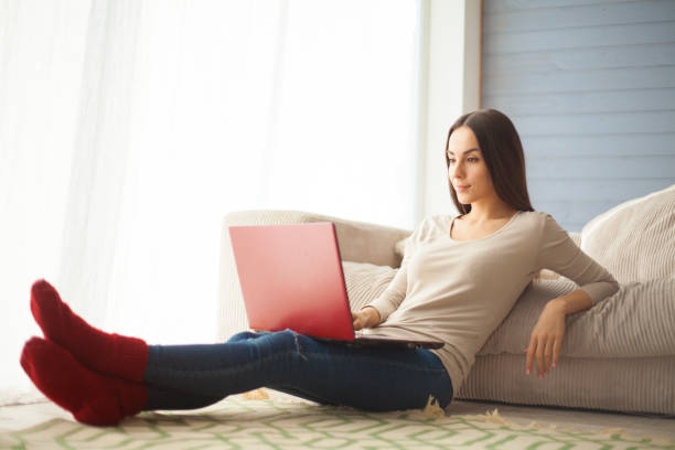 istock Woman uses laptop on the floor 682289616