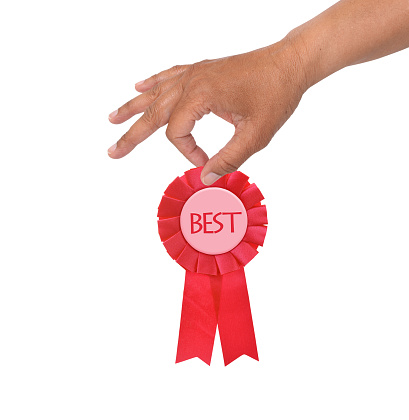 Hand holding best red ribbon isolated on white background