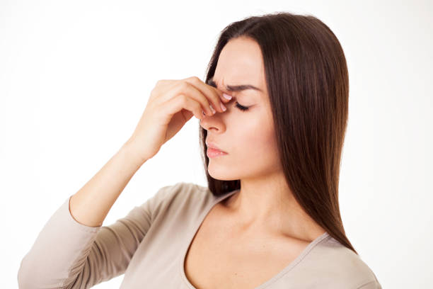 istock A terrible headache in a woman is isolated on white. 682292180