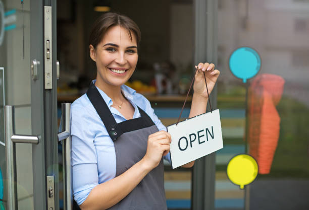 istock Woman holding open sign in cafe 682295946