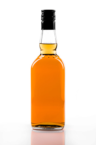 Small glass bottle of olive oil with a cork insert on a white background.