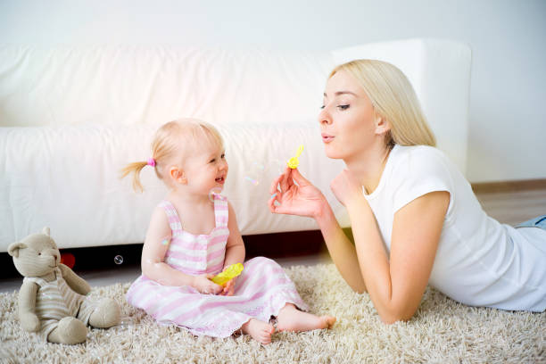 istock Mother playing with her baby daughter 682299754