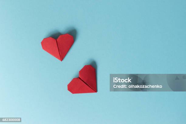 Two Red Origami Hearts On A Blue Background View From Above The Concept Of Valentines Day Stock Photo - Download Image Now