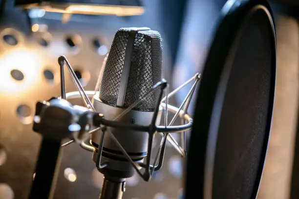 Photo of Modern professional microphone in recording studio