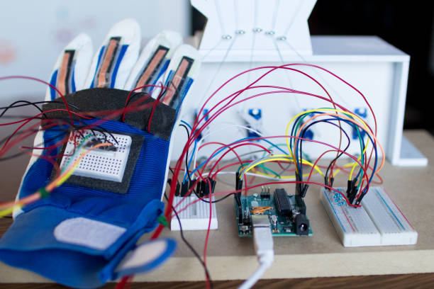 istock Robotic hand controlled by servomotors and glove with bending sensors. 682308168