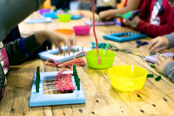 Educational weaving and knitting activity. Knitting wool for kids. knitting needle photos stock pictures, royalty-free photos & images