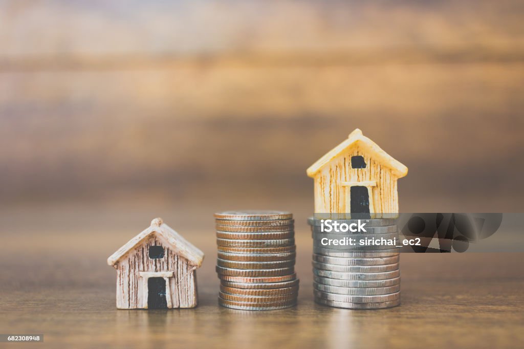 Coin money and house model on wooden background Coin money and house model on wooden background , Finance and banking concept. House Rental Stock Photo