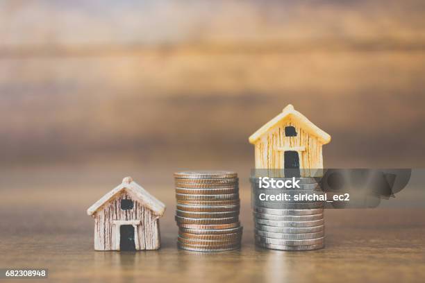 Coin Money And House Model On Wooden Background Stock Photo - Download Image Now - House Rental, Backgrounds, Business